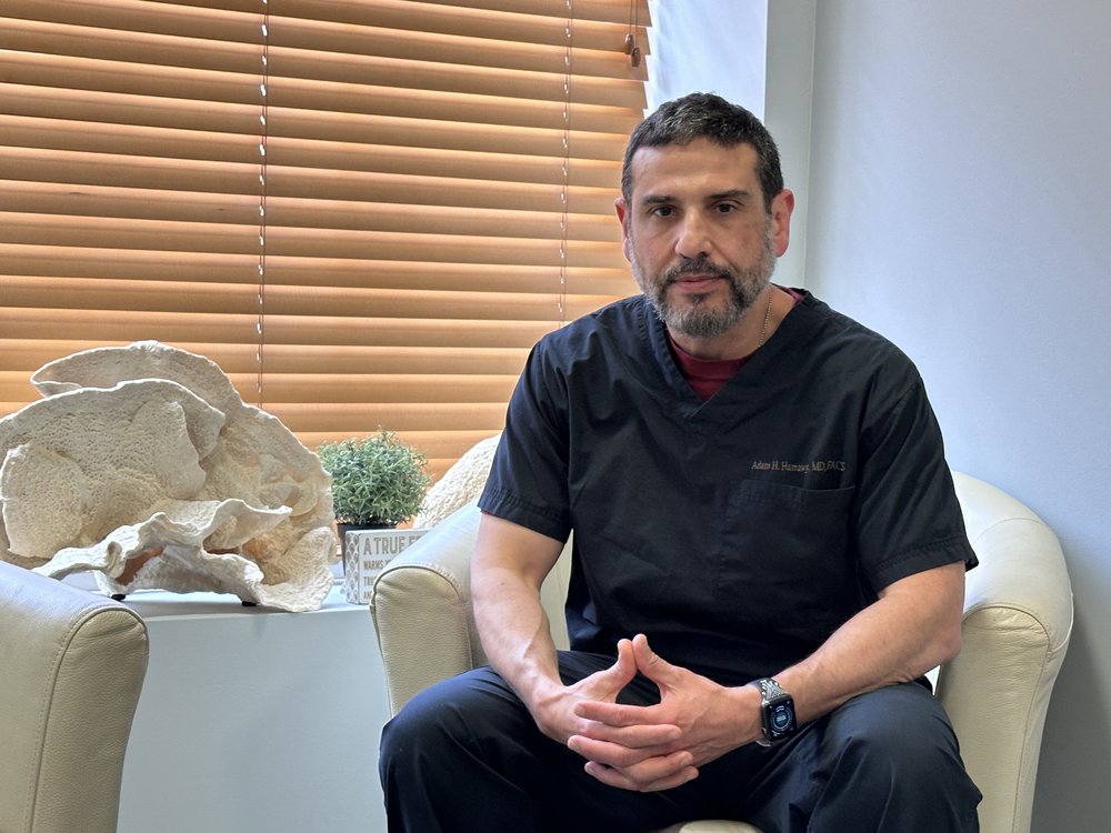 Dr. Adam Hisham Hamawy sitting in an office in New York.