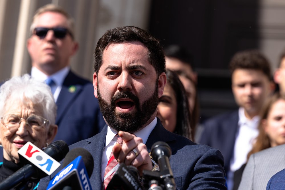 Mike Lawler points while speaking at a press conference.