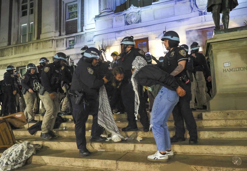NYPD cops place young people under arrest outside of Columbia's Hamilton Hall.