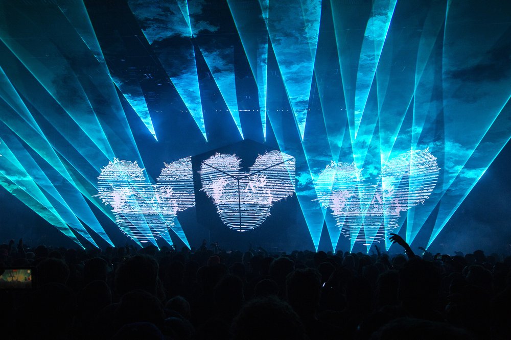 An indoor concert venue with blue lights.