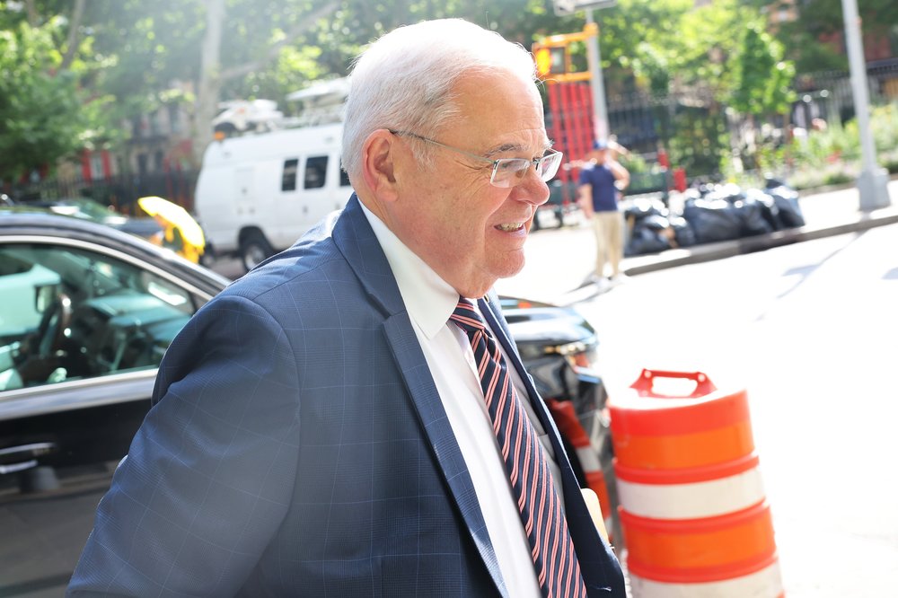 Sen. Bob Menendez (D-NJ) walks along a sidewalk outside Manhattan Federal Court on June 11.