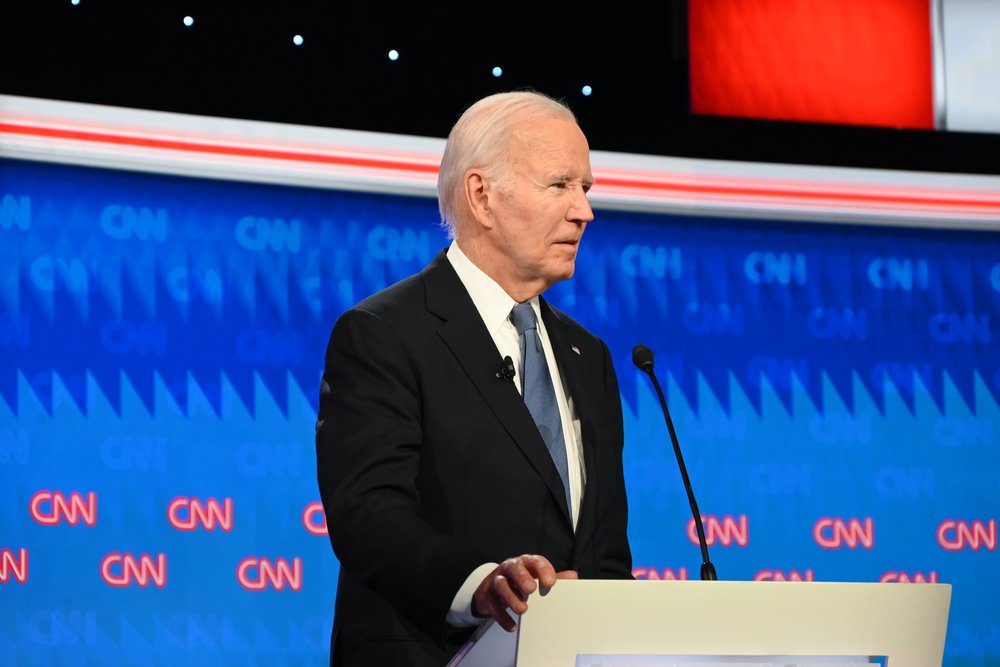 President Joe Biden stands at a debate stage.
