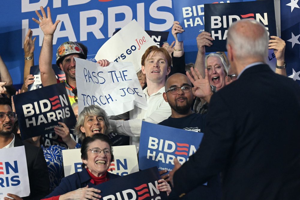 A sign at a Joe Biden rally reads "Pass the torch, Joe."