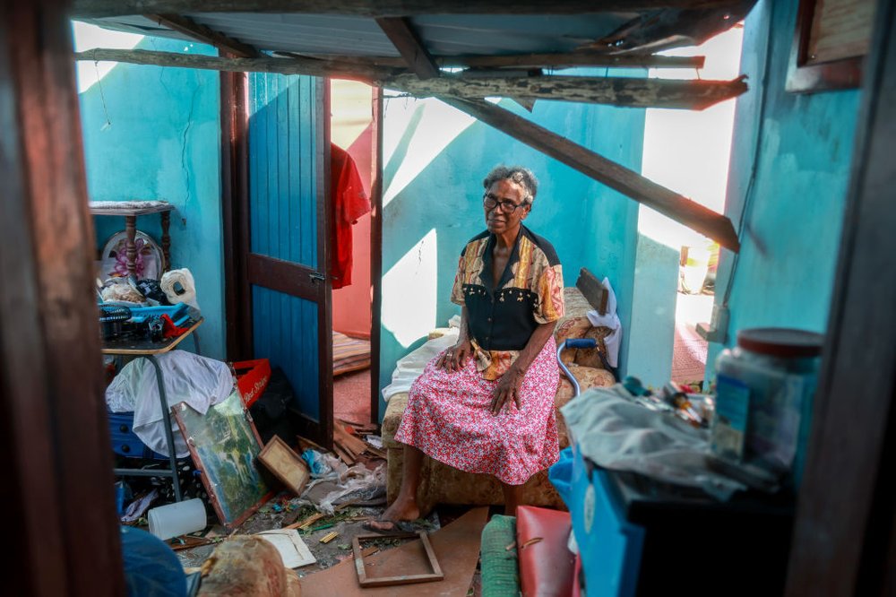 Clessie Taylor sits in what is left of her home in Saint Elizabeth Parish, Jamaica, after the roof was blown off by Hurricane Beryl as it passed through the area on July 4. Hurricane Beryl continues toward Mexico after causing destruction through the Caribbean islands.