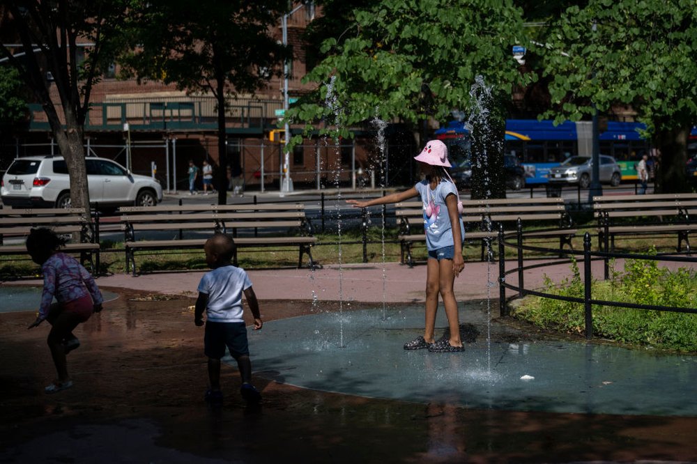 Children play in a spray park during a heat wave in the Bronx on July 11, 2024.
