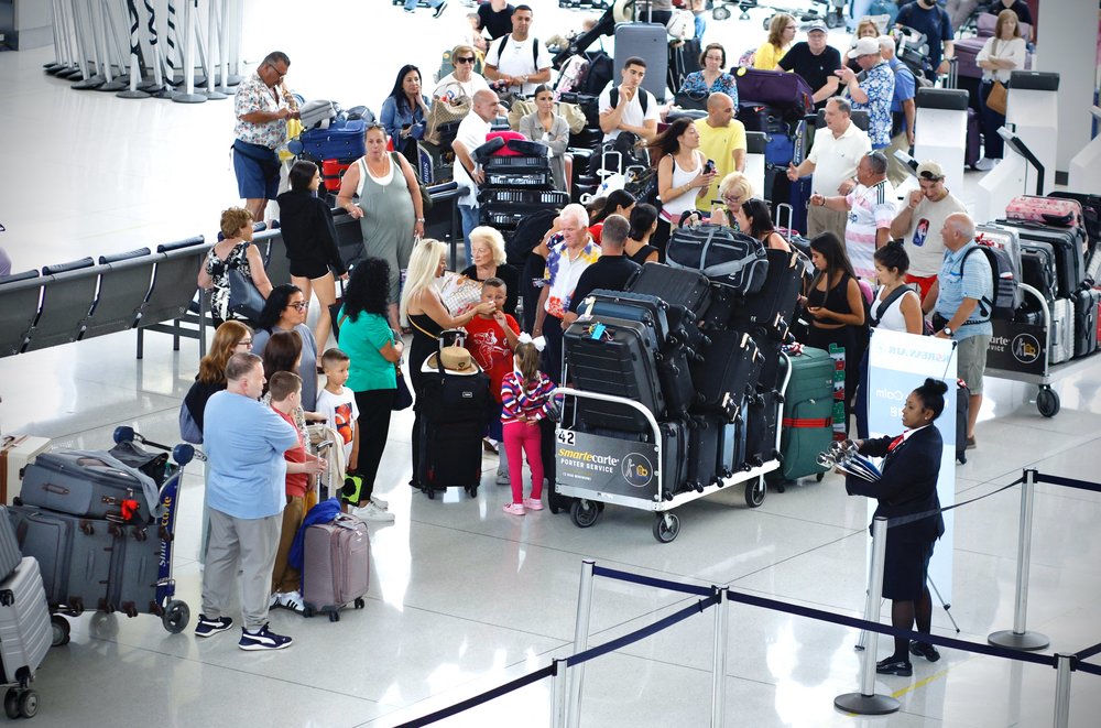 Passengers wait at JFK Airport's Terminal 1 in Queens on July 20, 2024.