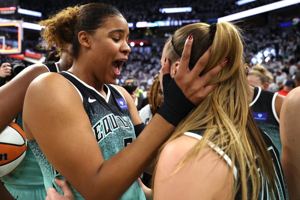 Nyara Sabally of the New York Liberty holds Sabrina Ionescu's face while celebrating after defeating the Minnesota Lynx 80-77 in game 3 of the WNBA Finals at Target Center on Oct. 16.
