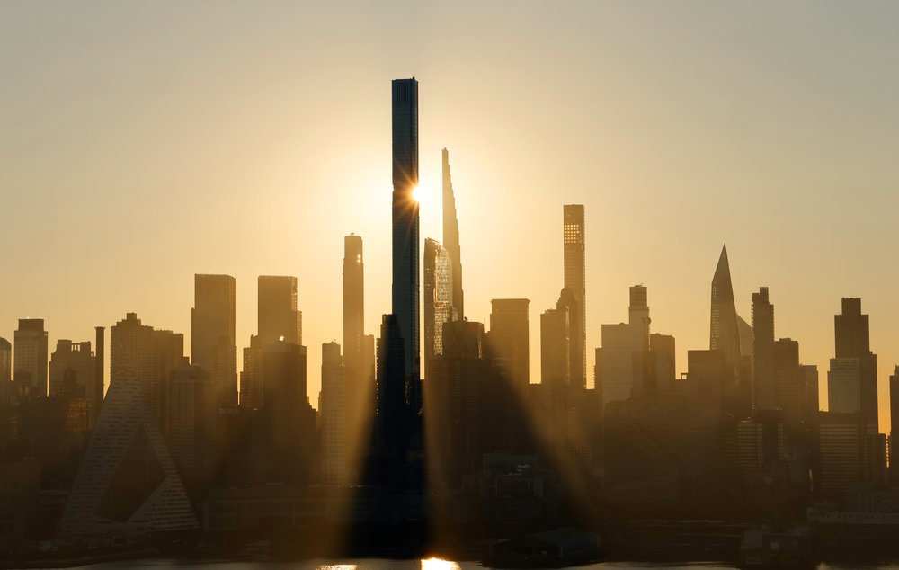The sun rises behind Central Park Tower and buildings along Billionaires' Row in New York City, as seen from Weehawken, New Jersey.