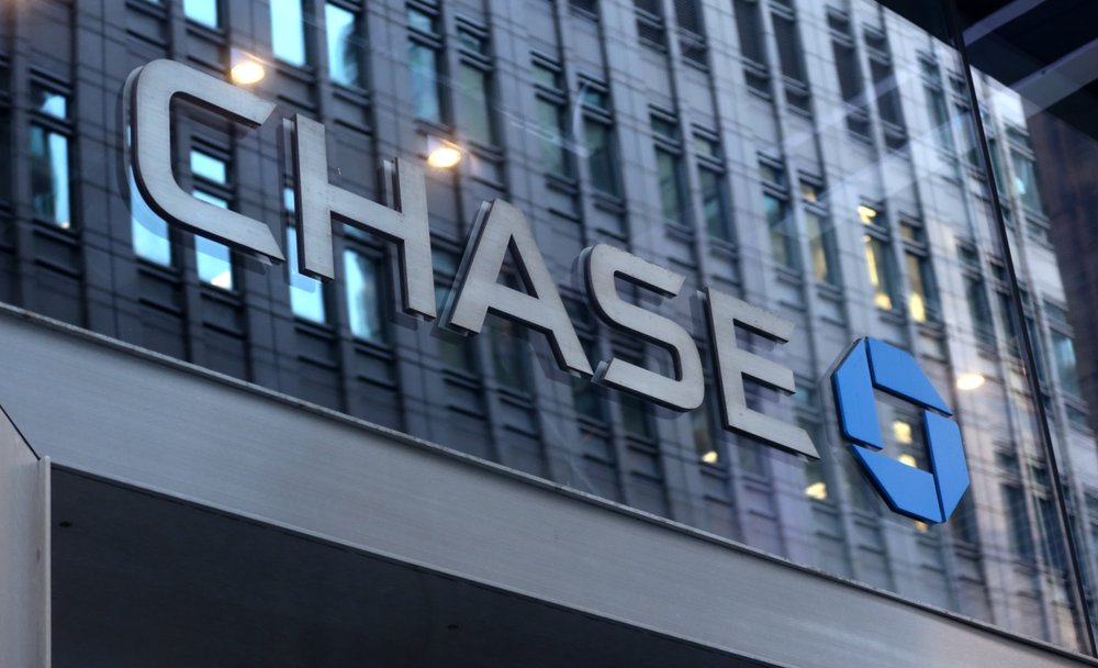 A Chase corportate logo above the entrance to a bank branch.