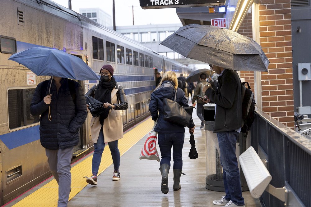 Commuters in the rain at the Mineola LIRR station on November 21, 2024.