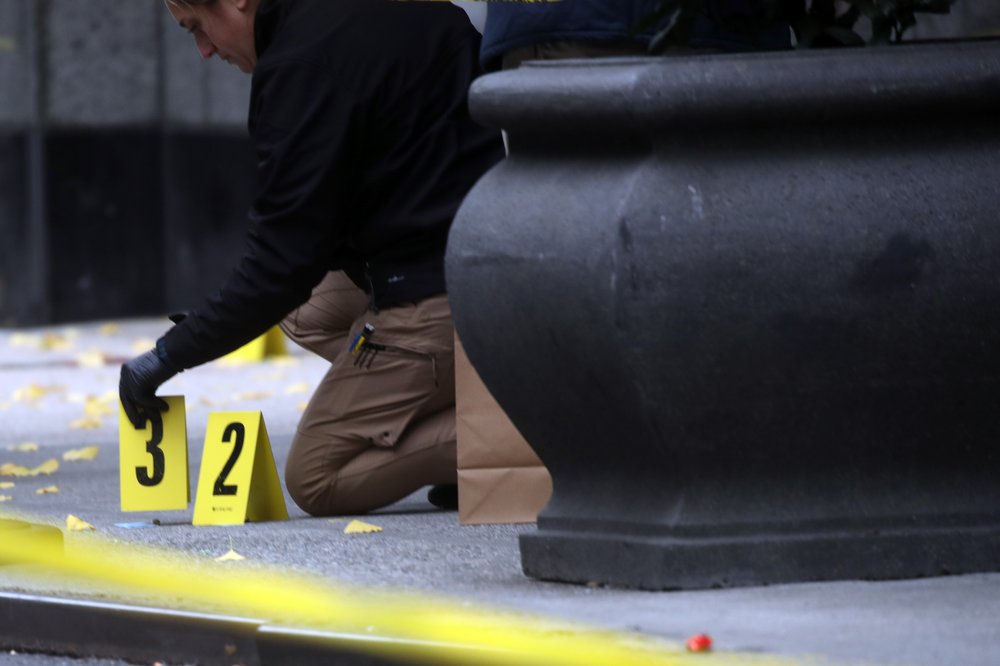 Police place bullet casing markers outside of a Hilton Hotel in Midtown Manhattan where United Healthcare CEO Brian Thompson was fatally shot on Dec. 04