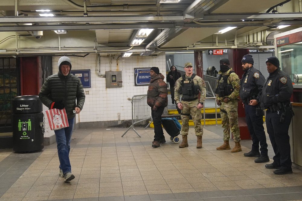 National Guard soliders and NYPD cops at the turnstiles.