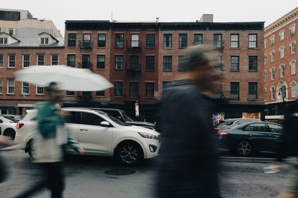 New Yorkers walk in cloudy weather.