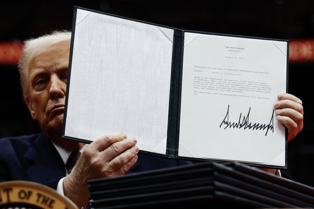 President Donald Trump holds up an executive order after signing it during an indoor inauguration parade at Capital One Arena on Jan. 20, 2025, in Washington, D.C.
