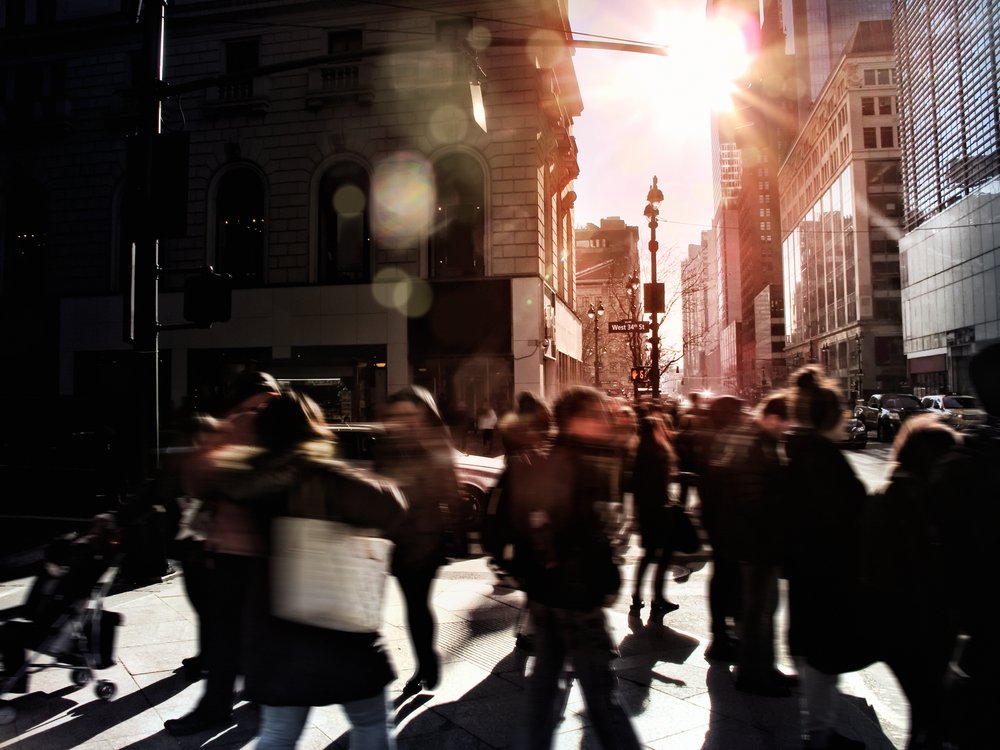 New Yorkers crossing a busy city street.