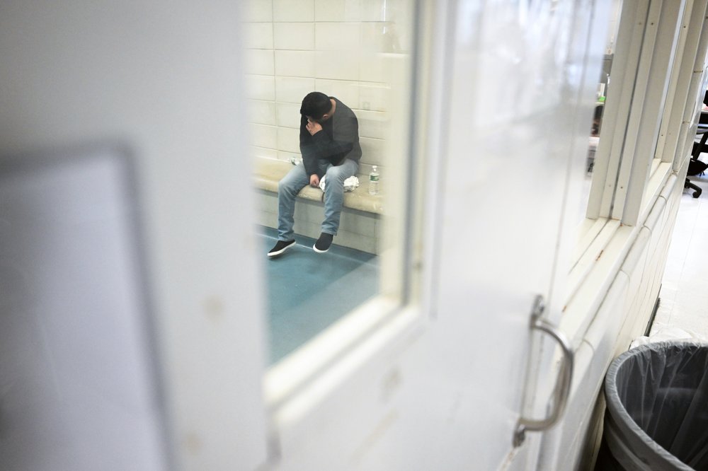 Leonardo Fabian Cando Juntamay as he sits in a holding cell in a processing area at 26 Federal Plaza after he was detained during ICE-led operations on Tuesday in New York City.