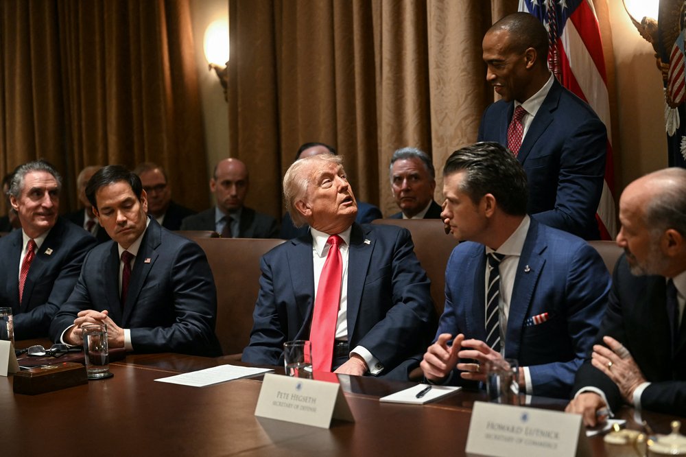 President Donald Trump speaks to Secretary of Housing and Urban Development Scott Turner during a cabinet meeting at the White House in Washington, DC, on February 26, 2025. Also pictured, L-R, Secretary of the Interior Doug Burgum, Secretary of State Marco Rubio, Secretary of Defense Pete Hegseth and Secretary of Commerce Howard Lutnick.