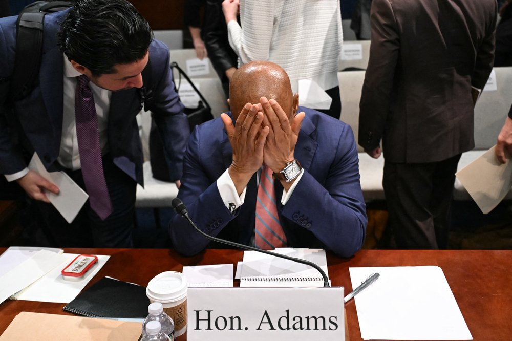 Mayor Adams with his head in his hands.