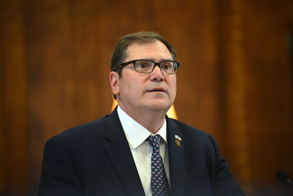 A man in glasses and a suit