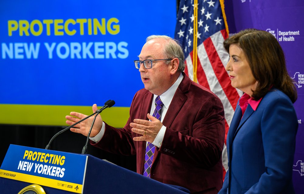 Gov. Kathy Hochul listens as state Department of Health Commissioner Dr. James McDonald gives an update on the statewide response to recent measles outbreaks during a press conference March 19, 2025, at the David Axelrod Institute Wadsworth Center in Albany.