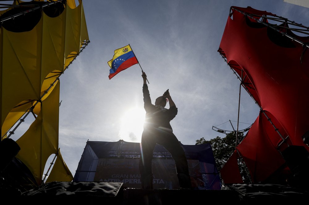 A man waves a Venezuelan flag during a march in support of Venezuelan migrants deported from the United States to El Salvador, in Caracas, on April 2, 2025.