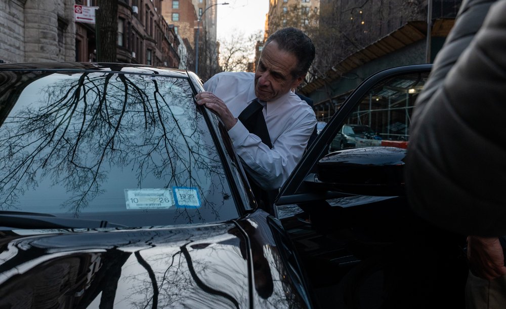 Cuomo gets into his black Dodge Charger.