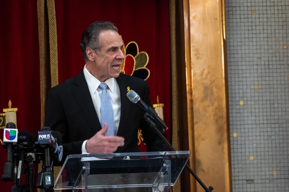 Andrew Cuomo speaks at a podium.