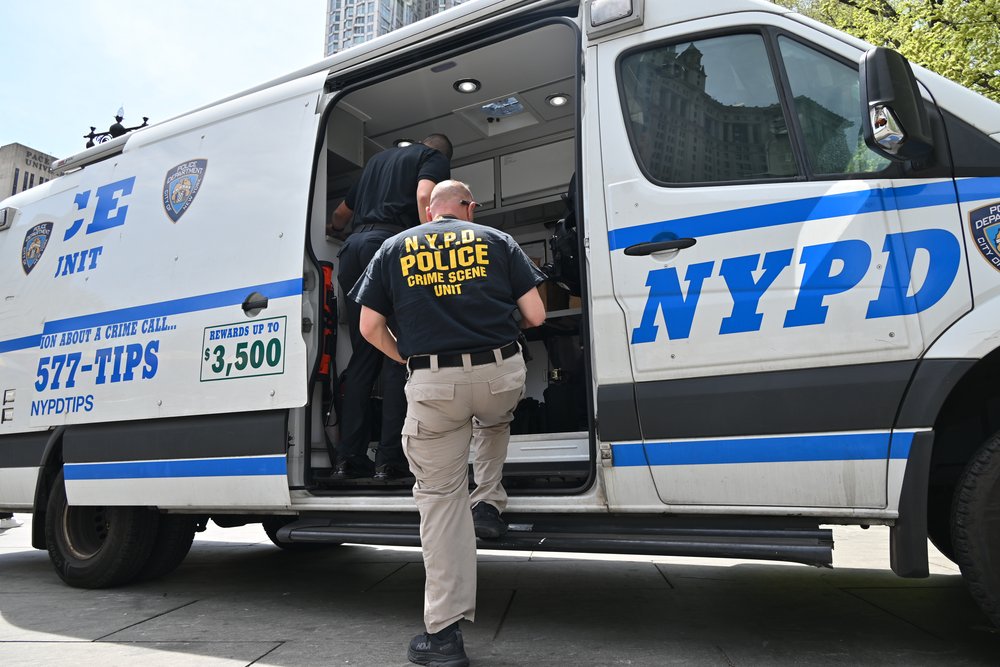 Members of the NYPD's crime scene unit collect evidence after a fatal stabbing in Lower Manhattan on April 25, 2025.
