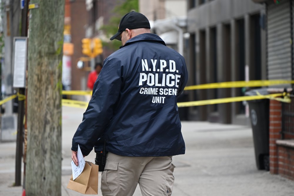 A police officer at the scene of a shooting