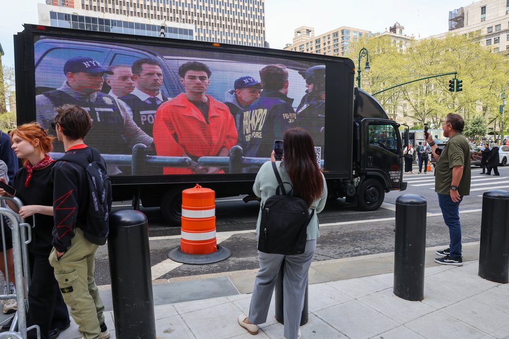 A truck displays pictures of Luigi Mangione as his supporters gather outside a federal court in Manhattan in April.