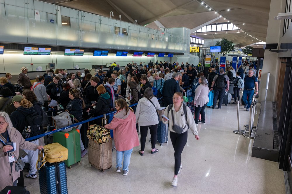 People wait in line for a delayed flight at Newark International Airport.