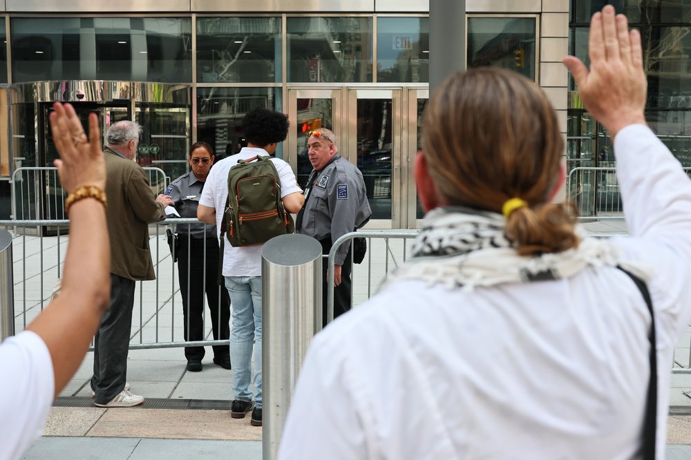 People pray outside of immigration court as people enter at Federal Plaza Immigration Court on May 8, 2025, in New York City