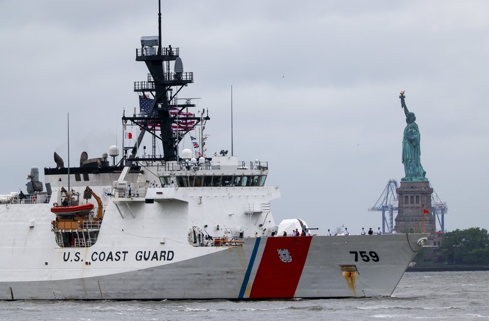 A U.S. Coast Guard vessel cruises through New York Harbor near the Statue of Liberty as part of Fleet Week on May 21, 2025.