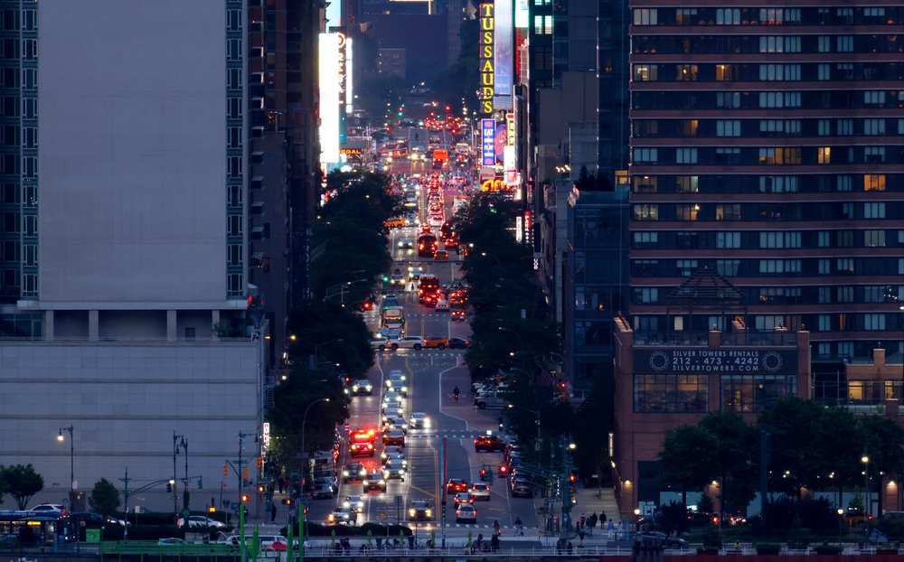 A row of cars in Manhattan, flickering in the evening light, a sign of life in New York City, the only place where you'd ever want to live.