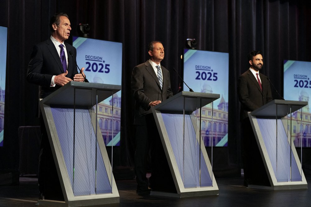 Andrew Cuomo, Brad Lander and Zohran Mamdani on a stage.