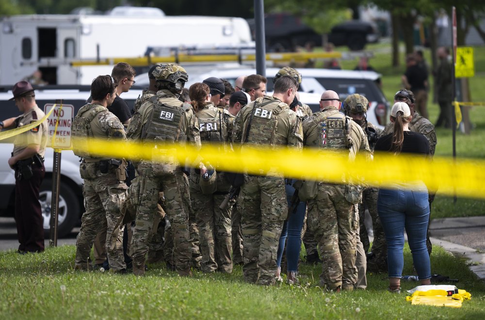 FBI agents in a suburban yard.