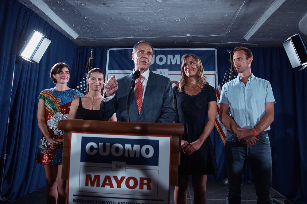 Andrew Cuomo at a podium with family.