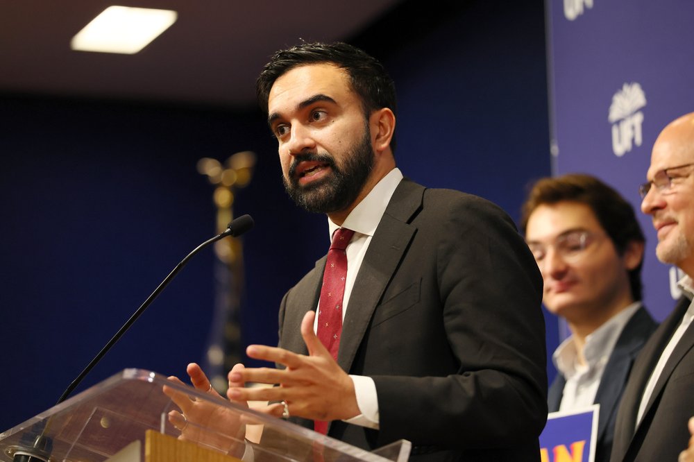 Mamdani at a podium.