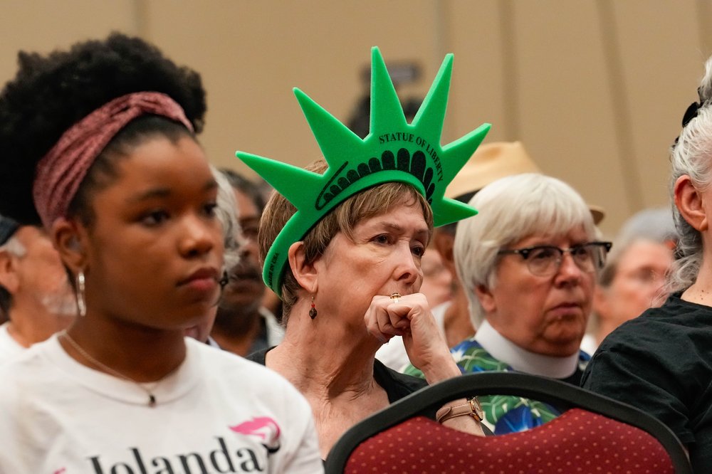People sitting in a hearing.