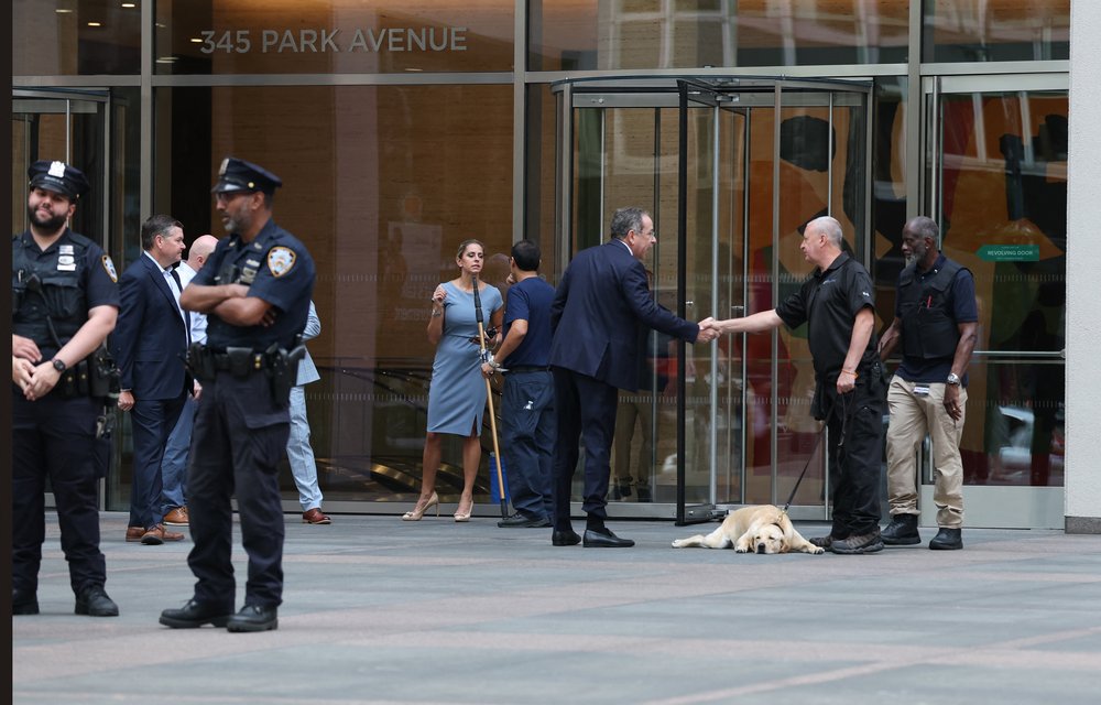 Thomas R. Nides, Vice Chairman for Strategy and Client Relations at Blackstone, shakes hands with a security officer as he enters 345 Park Avenue as the building partially reopens following last week's deadly shootings in Midtown Manhattan, in New York on August 4, 2025.