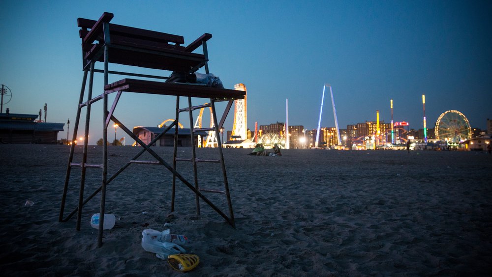 An empty lifeguard chair at night at Coney Island in Brooklyn, New York.