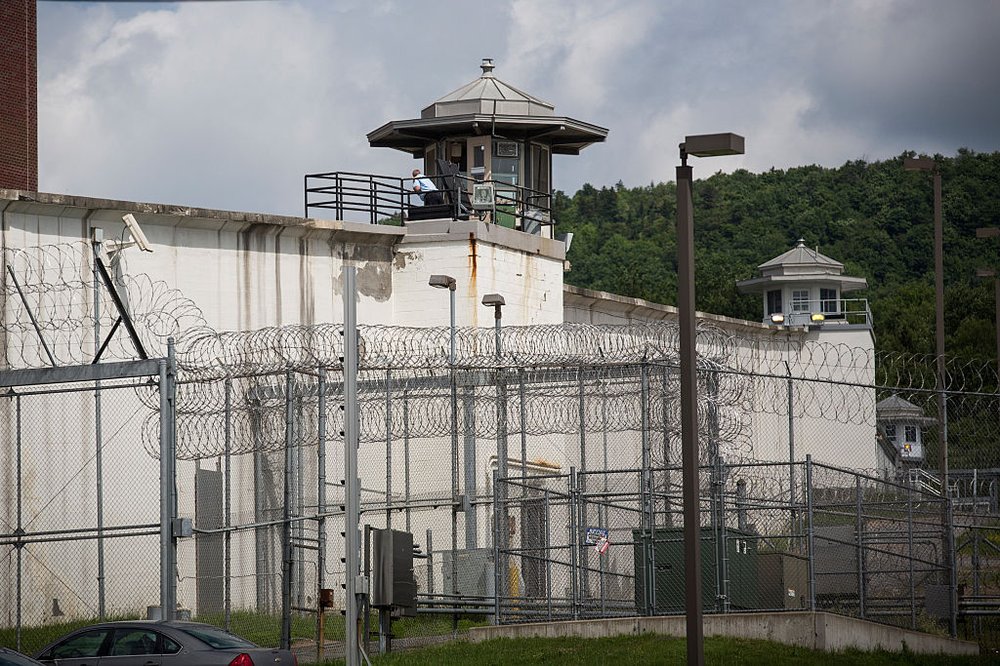The Clinton Correctional Facility in upstate New York, a facility encapsulated by thick high walls and a guard tower.