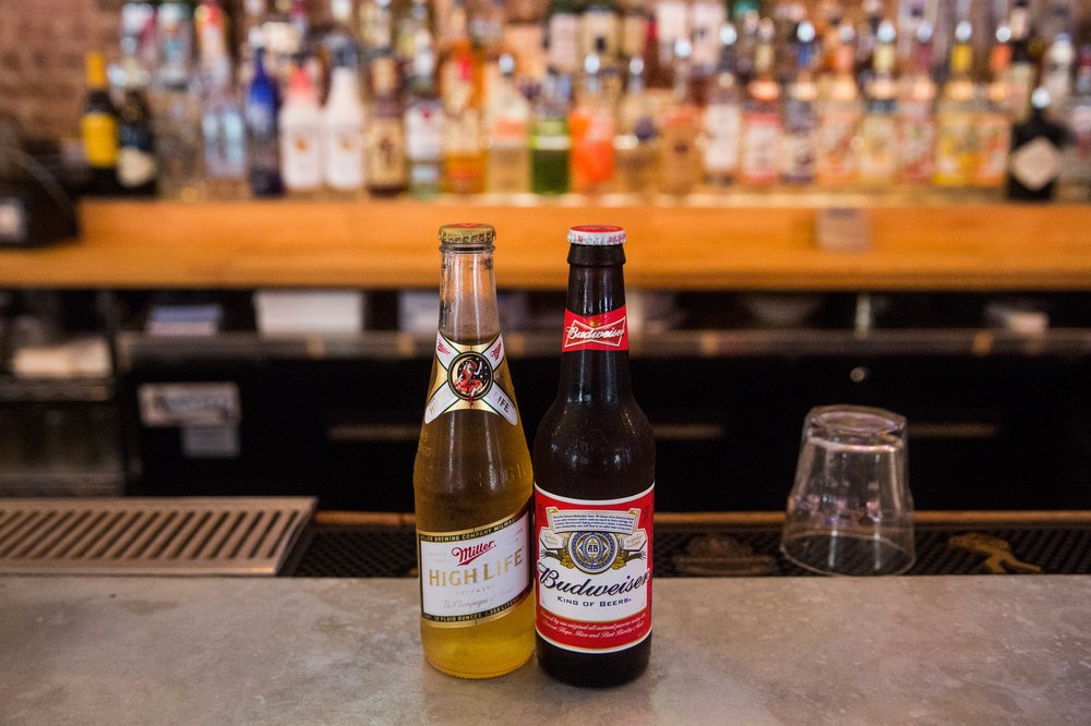 Two beers on a counter top.