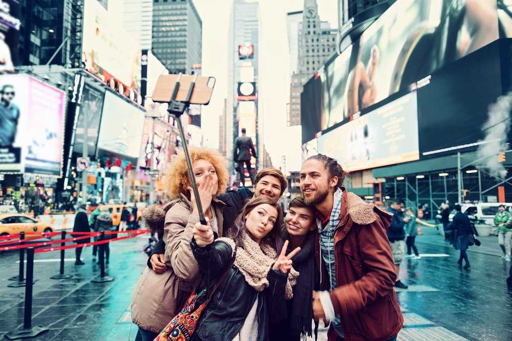 Tourists mugging for a selfie in New York City.