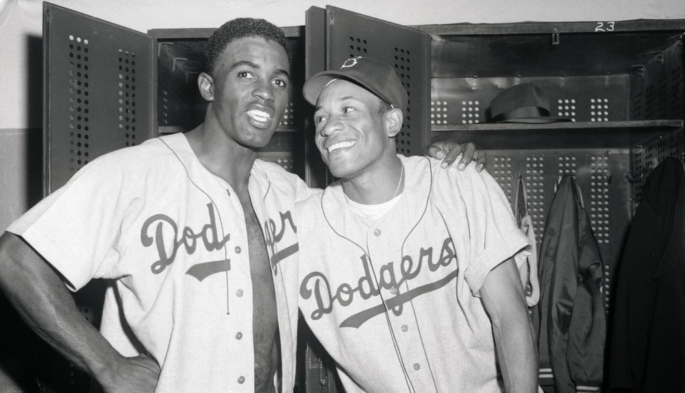 Two baseball players in Brooklyn Dodgers.