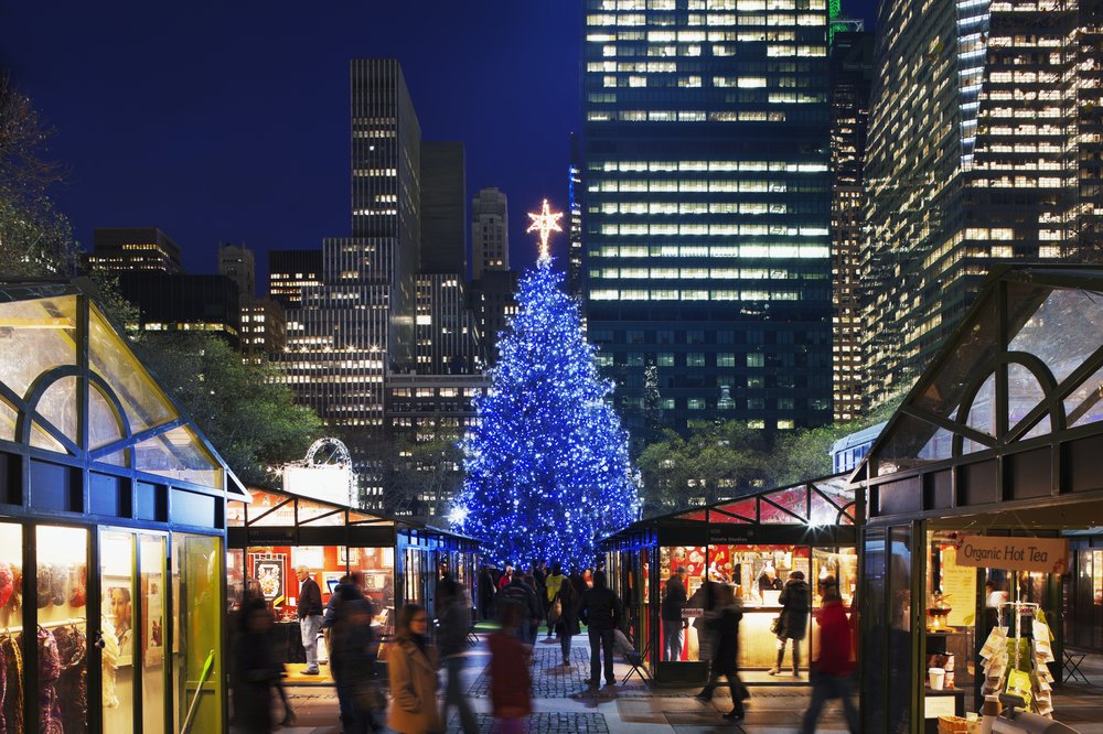 An illuminated Christmas tree in a holiday market.
