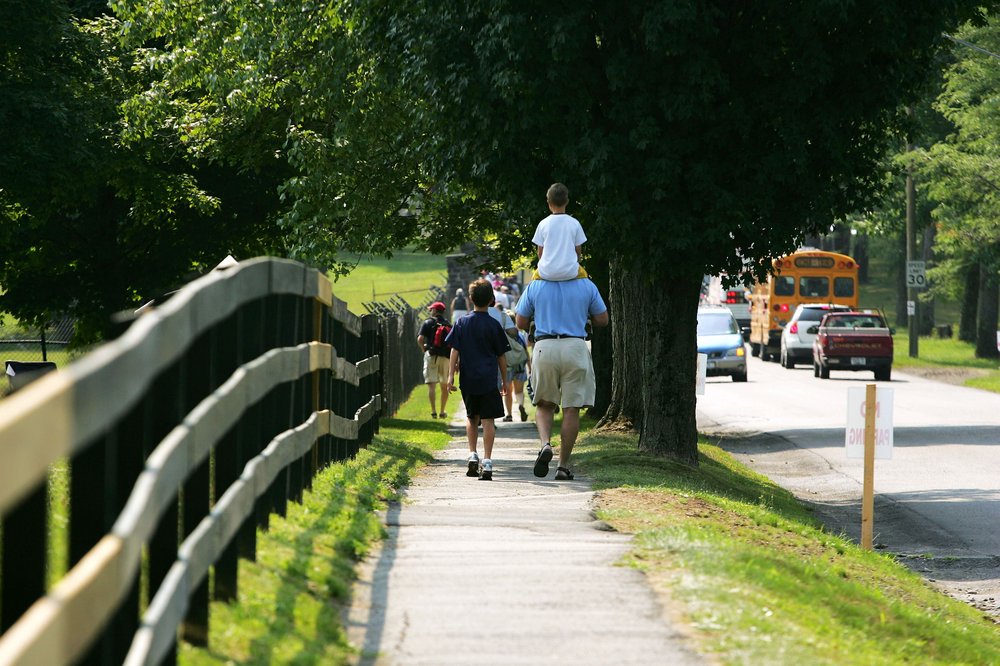 Families walking on a sidewalk.