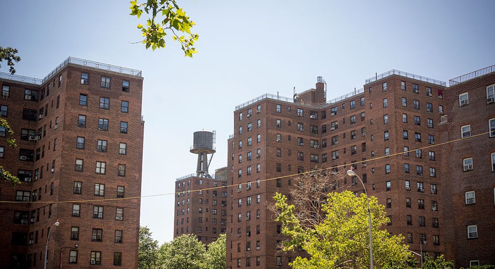 Street view of the Jacob Riis Houses in the East Village, a public housing complex with large brick buildings nearly identical to each other are lumped together.