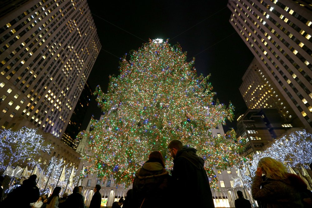 A view up at an enormous Christmas tree with lights