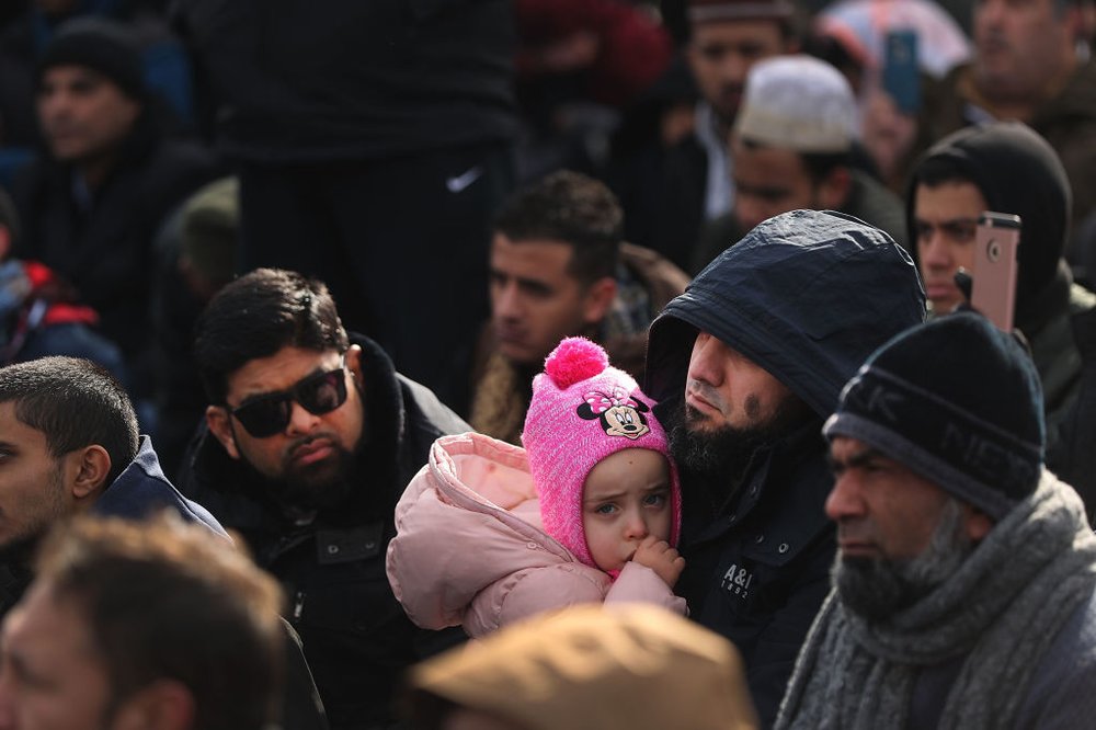 A muslim man holds his daughter as he prays at a prayer and demonstration at JFK airport to protest President Donald Trump's Executive Order banning immigrants and refugees from seven Muslim-majority countries on Feb. 3, 2017, in New York City.